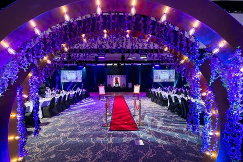 Ballroom entrance framed by illuminated floral arches and red carpet styling at a masquerade gala. Ballroom Transformation Installation