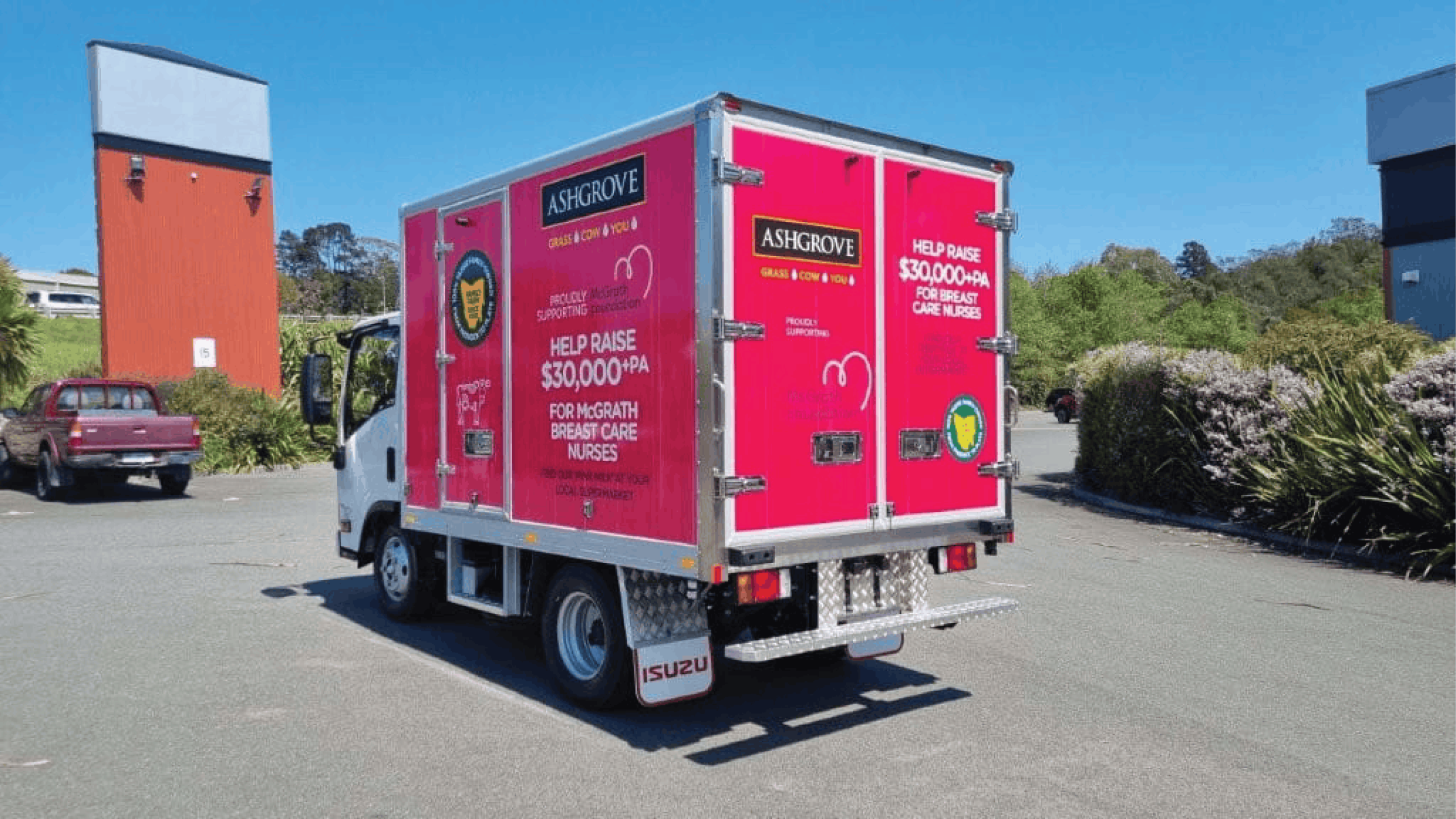 Ashgrove Truck Branding and Vehicle Graphics Ashgrove delivery truck with bright pink graphics promoting support for McGrath breast care nurses across its side and rear doors.