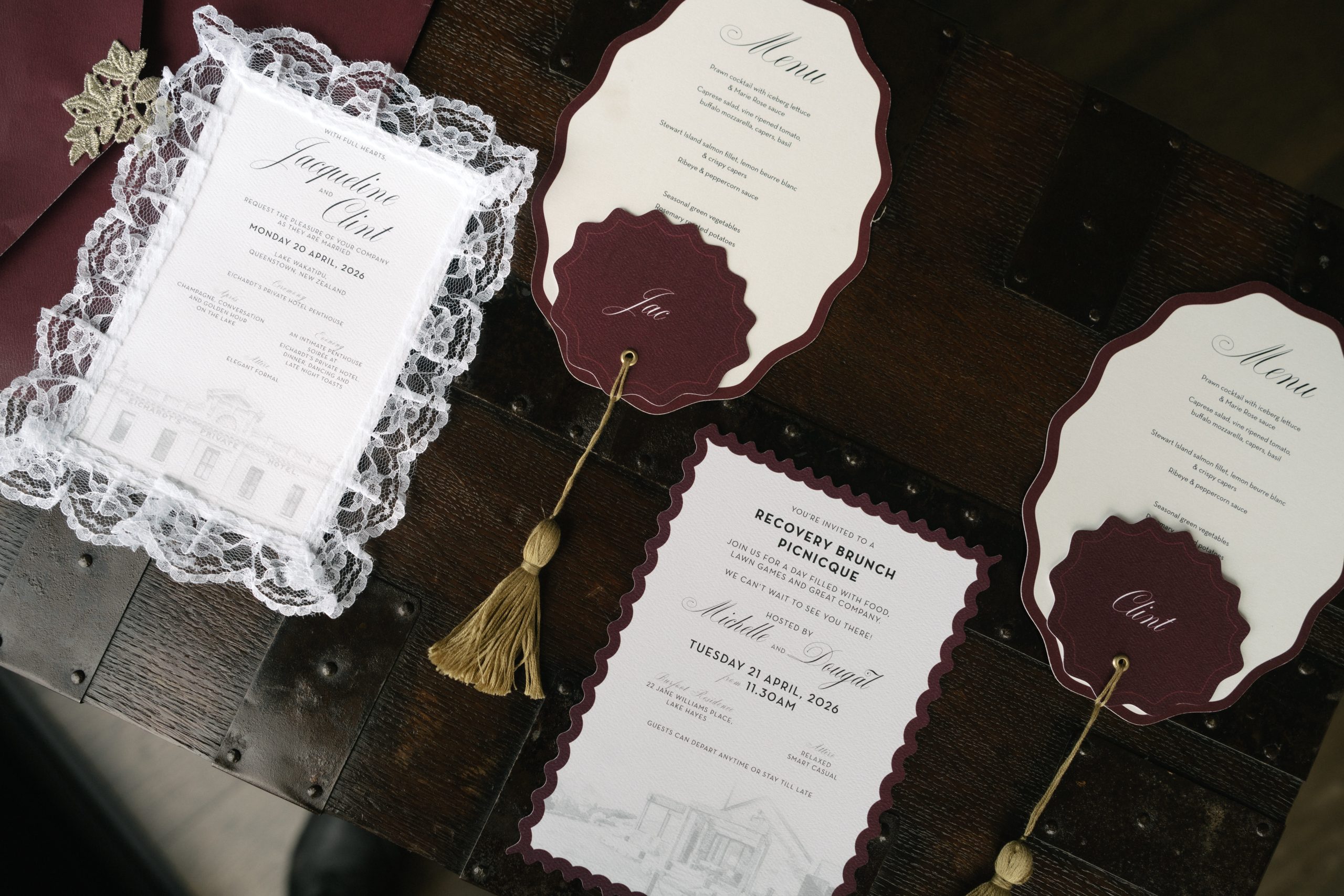 Jacqui and Clint Custom Wedding Stationery Suite Jacqui and Clint’s burgundy and ivory wedding stationery with a lace-bordered invitation, shaped menus, tasselled name tags and brunch invitation.